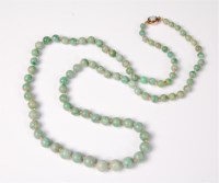 Lot 2605 - A jade and opal bead necklace, the graduated...
