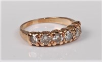 Lot 2656 - A six stone diamond ring, the six round...