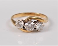 Lot 2657 - An 18ct three stone diamond ring, the three...