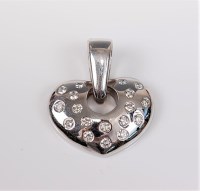 Lot 2668 - A diamond set heart pendant, the softly curved...