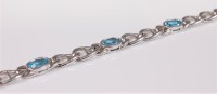 Lot 2670 - A 9ct white gold and topaz bracelet, the six...