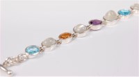 Lot 2672 - A silver and multi gemset bracelet, the mixed...