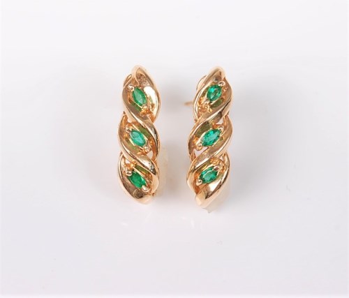 Lot 2680 - A pair of emerald earrings, the three small...
