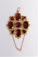 Lot 2683 - A garnet pendant, the oval faceted garnets, in...