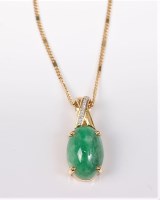 Lot 2685 - An 18ct jade and diamond pendant, the oval...