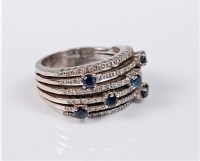 Lot 2706 - A contemporary sapphire and diamond ring, the...