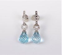 Lot 2712 - A pair of topaz and diamond earrings, the...