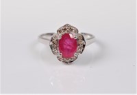 Lot 2717 - A 9ct treated ruby and diamond ring, the oval...