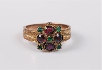 Lot 2719 - A garnet and green hardstone ring, the central...