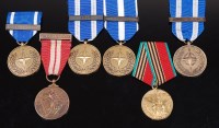 Lot 1073 - A collection of four Nato Service medals, each...