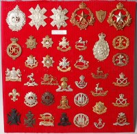 Lot 1097 - A collection of assorted cap badges and...