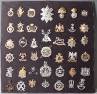 Lot 1104 - A large collection of assorted cap badges and...