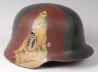 Lot 1175 - A German M40 pattern steel combat helmet with...