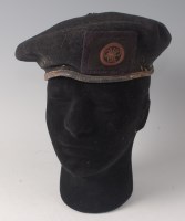 Lot 1265 - WITHDRAWN A blue beret, bearing a cloth badge...