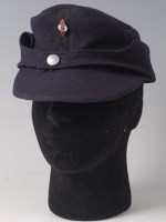 Lot 1288 - A German blue felt cap with enamelled Hitler...