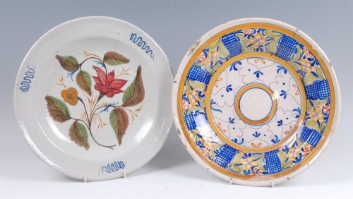 Lot 17 - An 18th century Delft charger, polychrome...