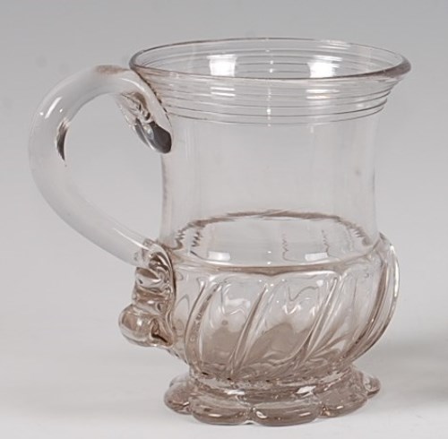 Lot 94 - An early 18th century glass pint jug, having a...