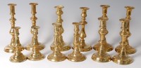 Lot 207 - Six pairs of 19th century brass candlesticks,...