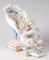 Lot 2058 - A 19th century Dresden porcelain cherub and...