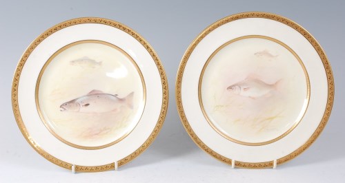Lot 2069 - A pair of Royal Doulton porcelain cabinet...