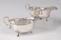 Lot 2095 - A cased pair of Edwardian silver sauceboats,...