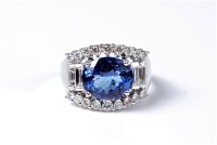 Lot 2130 - An 14ct tanzanite and diamond ring, the oval...