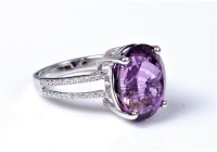 Lot 2132 - An amethyst and diamond ring, the oval...