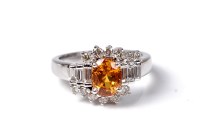 Lot 2168 - A 14ct yellow sapphire and diamond ring, the...