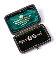 Lot 2176 - A diamond set riding crop brooch, the crop set...