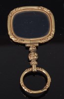 Lot 2235 - A yellow precious metal magnifying glass, the...