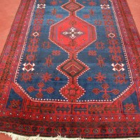 Lot 2463 - A Kurdish woollen rug, the blue ground...