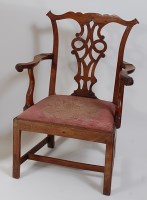 Lot 2469 - A George III fruitwood elbow chair, in the...