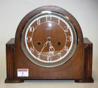 Lot 5 - A 1950s oak cased mantel clock, having...