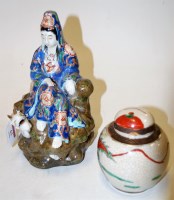 Lot 63 - A Chinese pottery figure of a lady in seated...