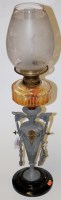 Lot 107 - An early 20th century oil lamp, having etched...