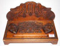 Lot 123 - A carved hardwood desk stand, having twin...