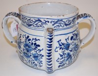Lot 187 - An 18th century Delft twin handled puzzle cup...