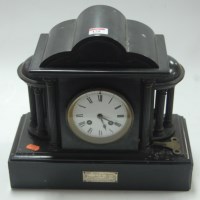 Lot 128 - A George V black slate mantel clock, having...