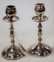 Lot 183 - A pair of George V silver table candlesticks,...