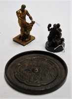 Lot 268 - A small bronze figure group of a seated man...