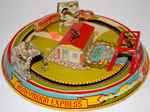 Lot 1506 - A Marx Toys tinplate and clockwork Honeymoon...