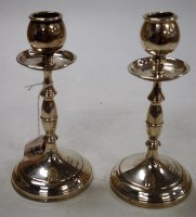 Lot 185 - A pair of George V silver table candlesticks,...