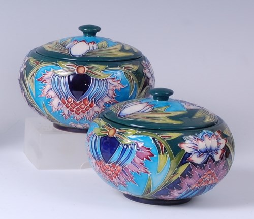 Lot 40 - A pair of Moorcroft pottery jars and covers in...