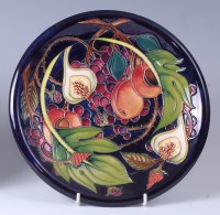 Lot 83 - A Moorcroft pottery plate in the Queens Choice...