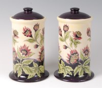 Lot 198 - A pair of Cobridge stoneware jars and covers...
