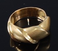 Lot 409 - A contemporary abstract gents gold dress ring,...