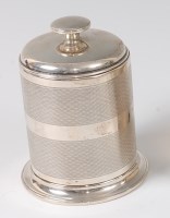 Lot 421 - A late Art Deco silver cylindrical table...