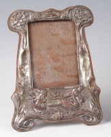Lot 459 - An Art Nouveau embossed silver plated easel...