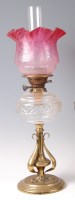 Lot 469 - An Art Nouveau brass oil lamp, having floral...