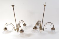 Lot 634 - A pair of Art Nouveau brass hanging three...